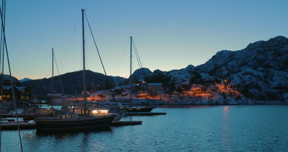 Boats sit docked at dusk