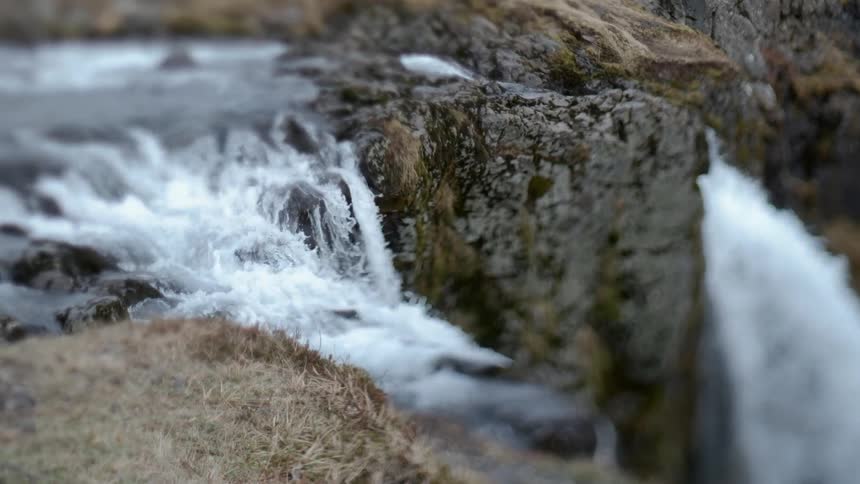 Water flows rapidly down a stream