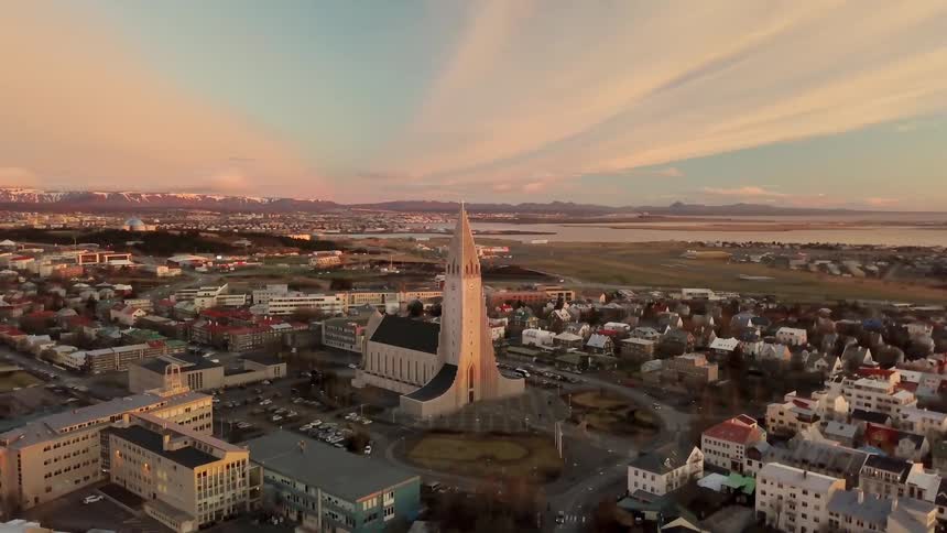 A church stands in the middle of a town at sunrise