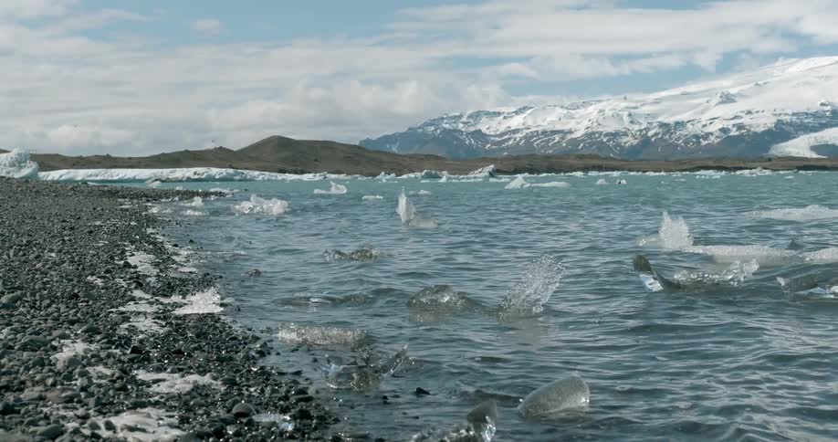 Icy waters rolling ashore on a cloudy day