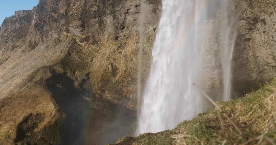 A waterfall flows over a cliff