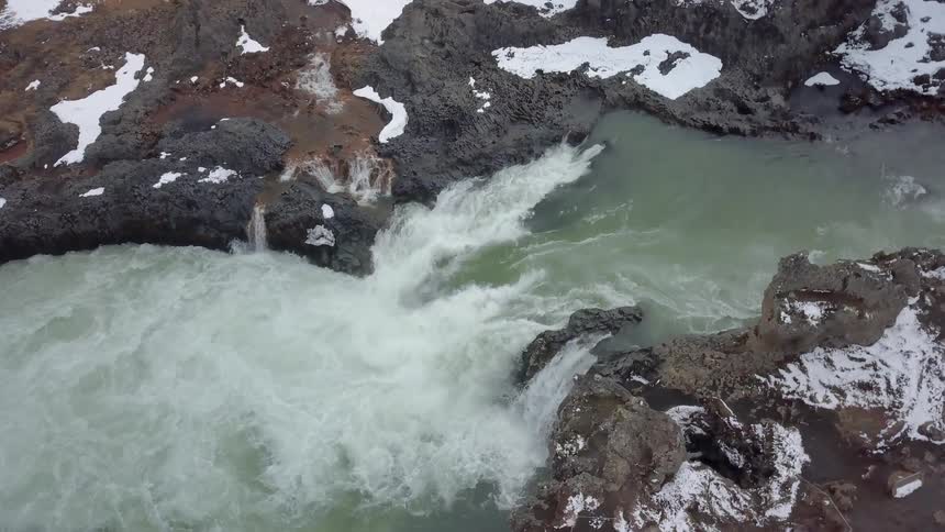 Water flows rapidly down a stream
