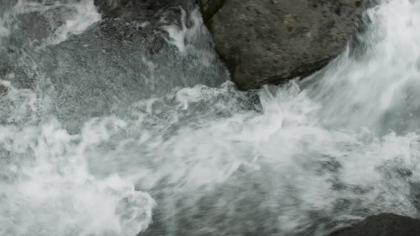 Water flows rapidly down a stream