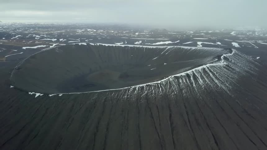 Snow covers the rim of a crater