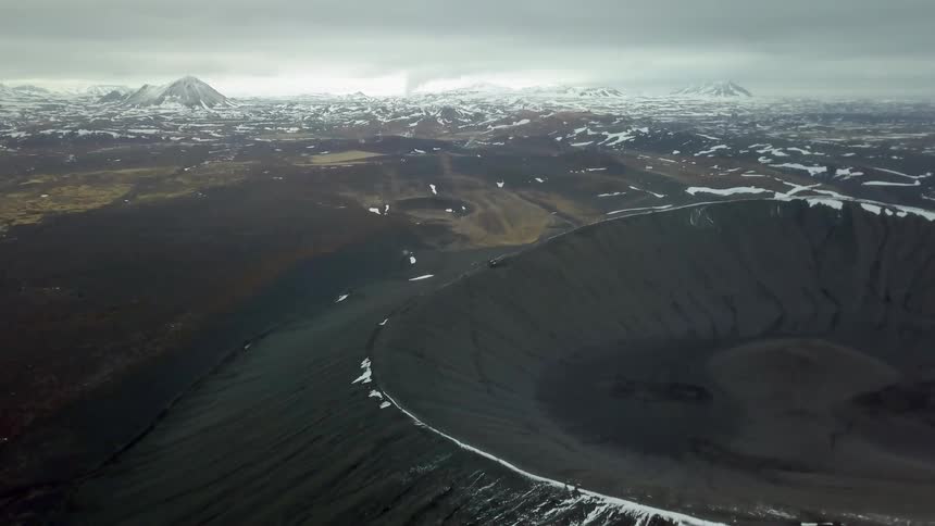Ice and snow cover the rim of a crater
