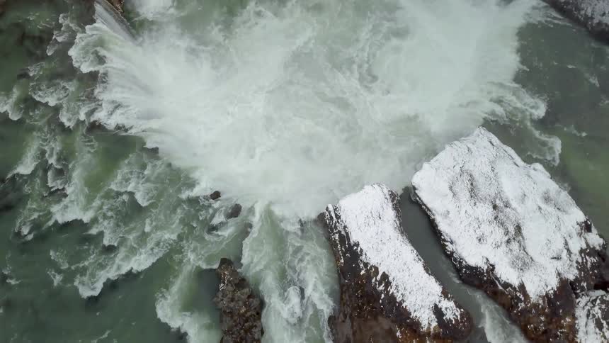 Water flows and pools together below cliffs