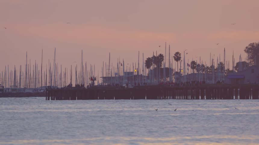 A harbor is shown at dusk