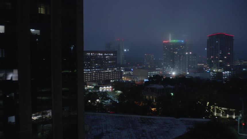 Lights from city buildings and traffic glow at night