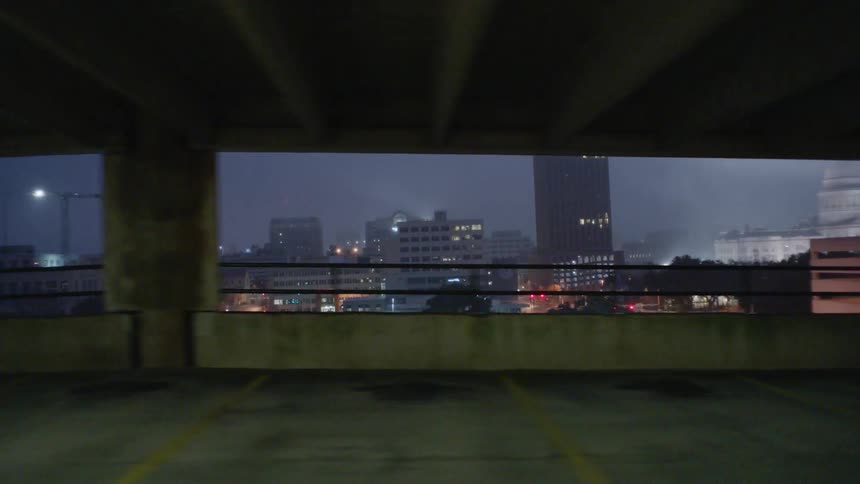 A car drives in a city parking garage