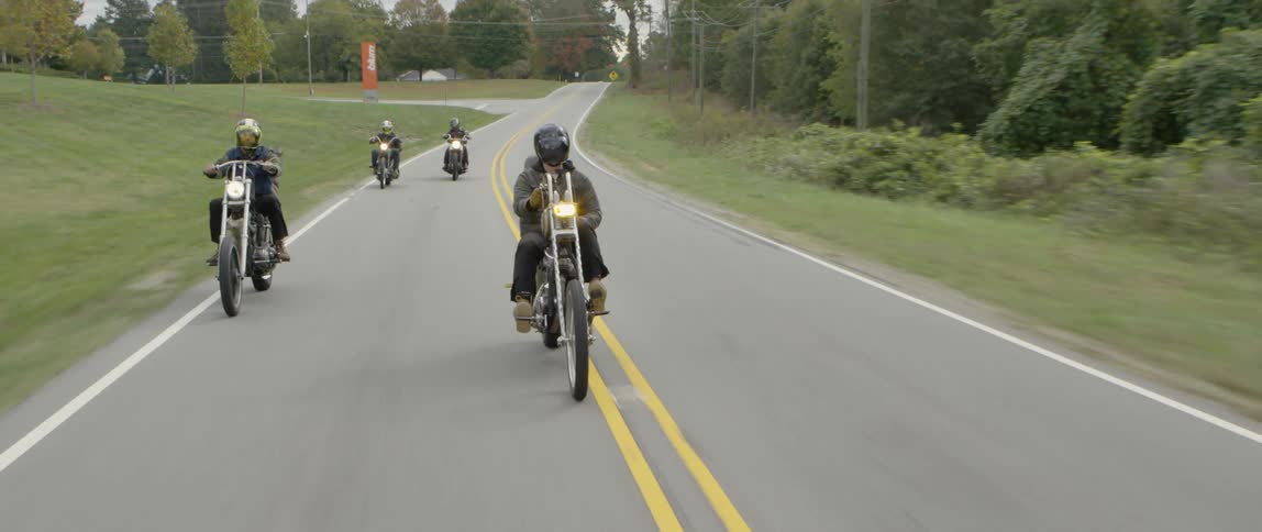 Motorcyclists ride together down the road