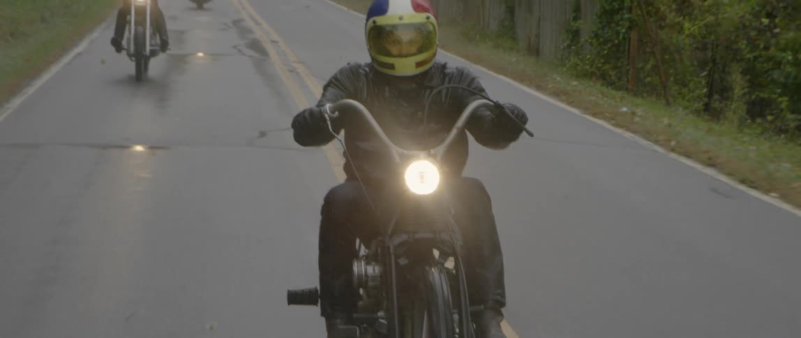 Motorcyclists ride down a mountain road