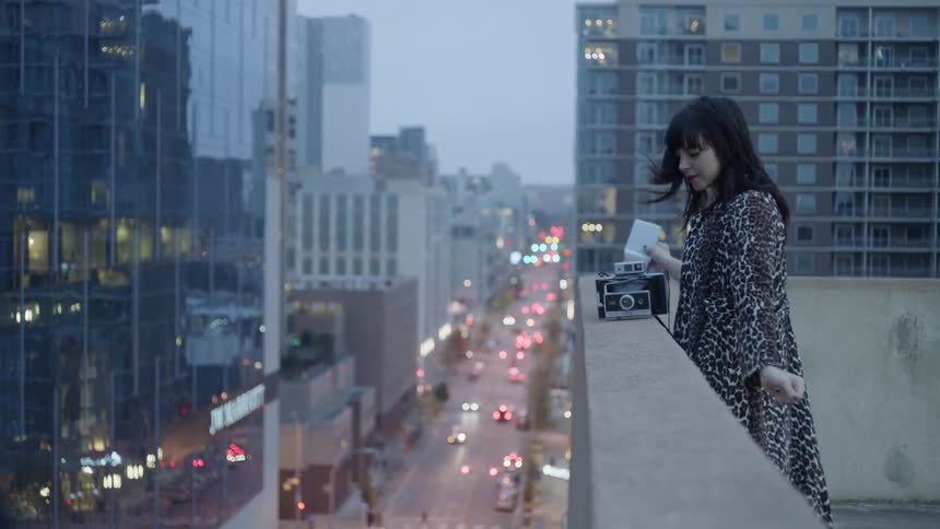 Woman does dance moves on a rooftop