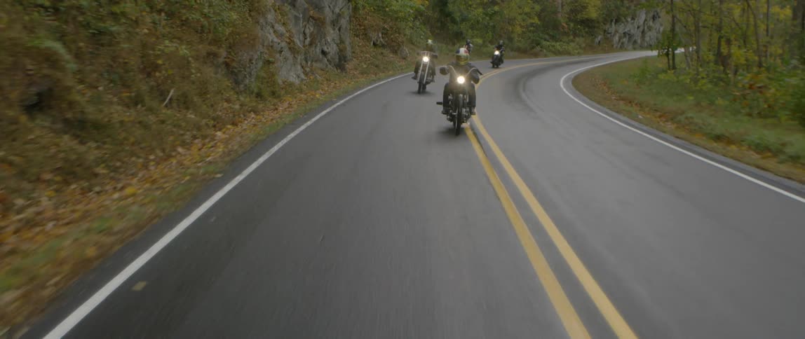 Motorcycles travel down a highway