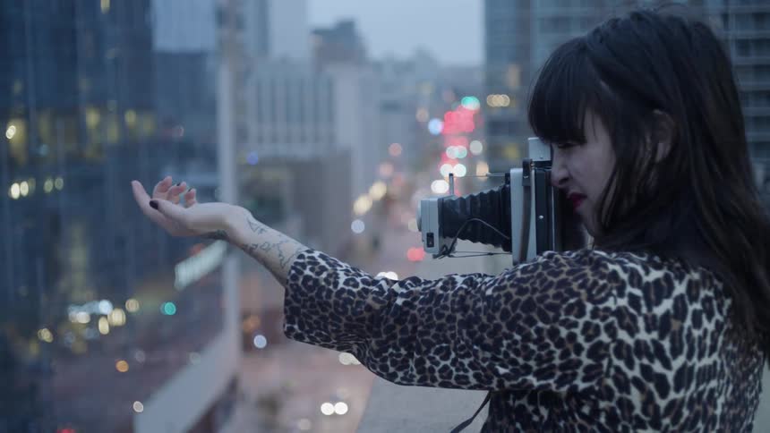 A woman takes a photograph of her arm