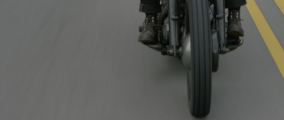 Someone is riding a motorcycle on the open road