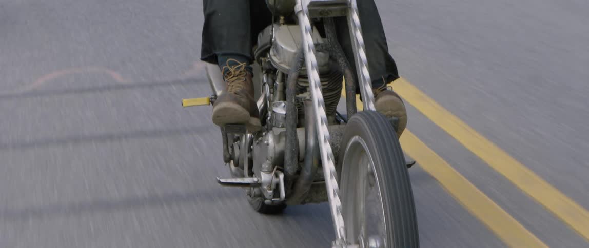 A motorcycle travels down the road
