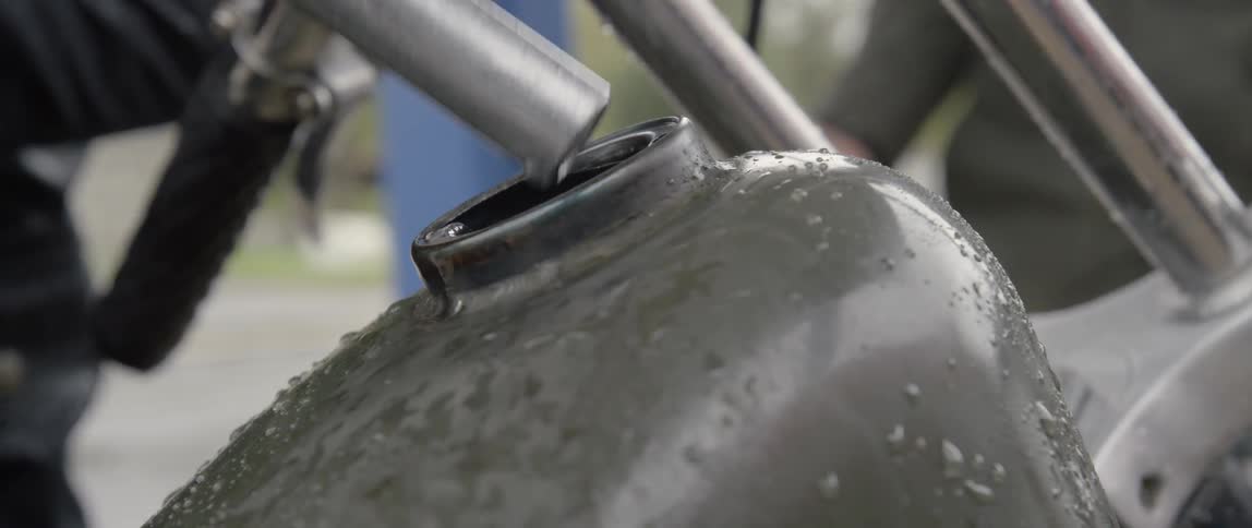 A motorcycle tank is filled with gas