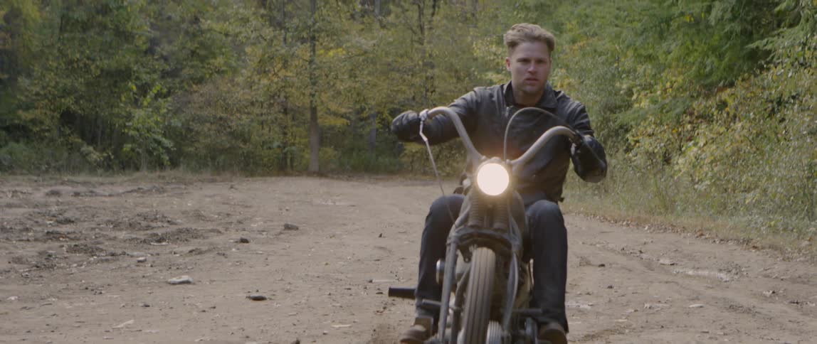A man is riding his motorcycle in the dirt