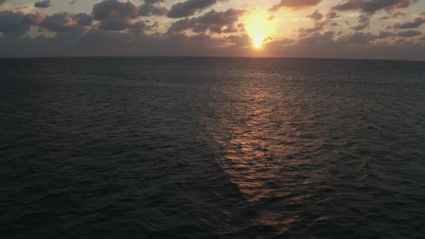 The sun sets over an ocean