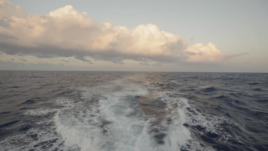 A boat floats on the ocean