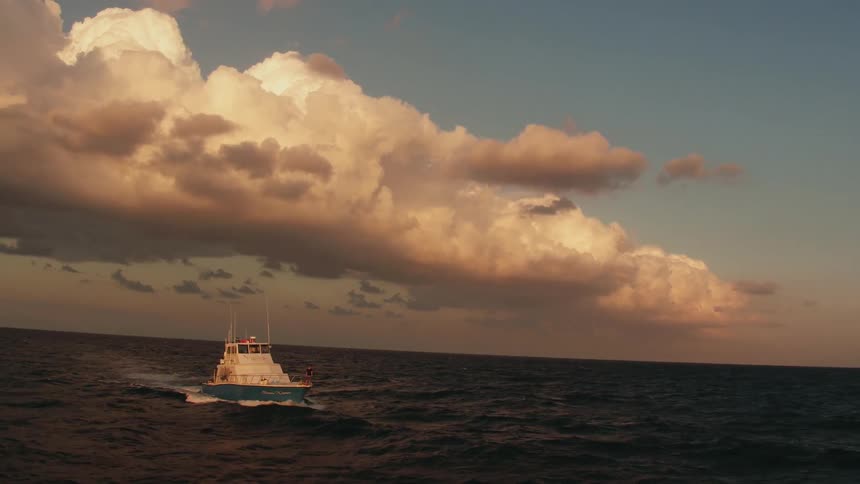 Boat rocking back and forth on the seas on a cloudy day