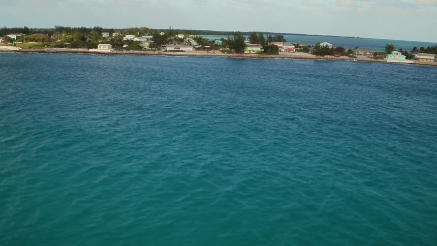 Waves flow gently towards the beach shore