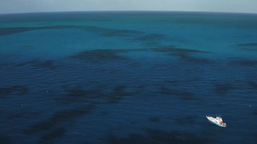 Boat sails on the open ocean