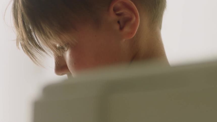 Child looks down at his hands