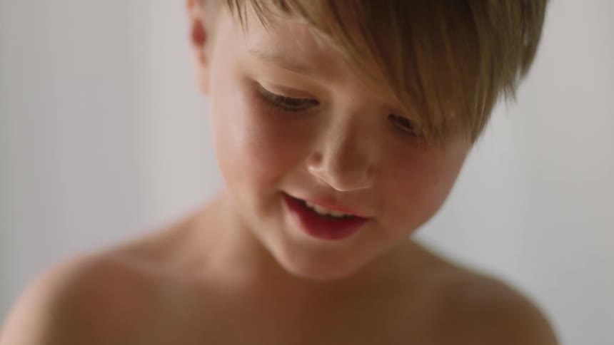 A young boy smiles indoors