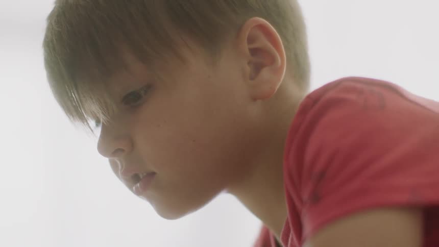 A young child is playing with something off screen