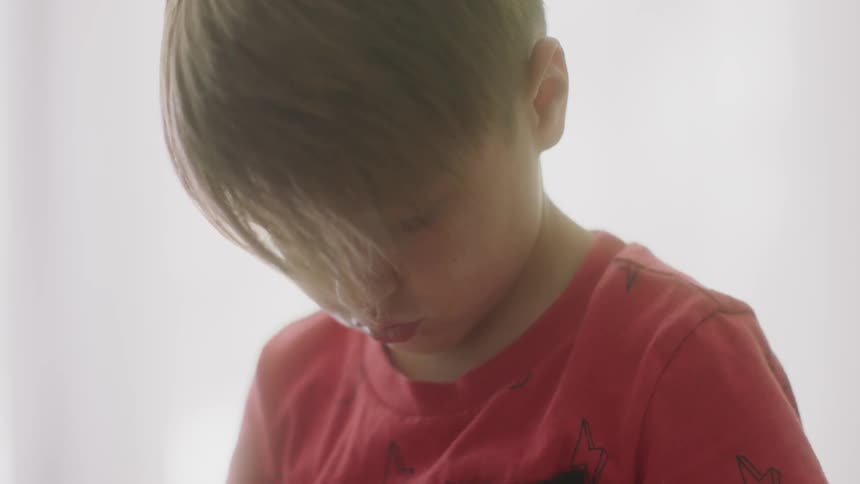 A young boy plays indoors