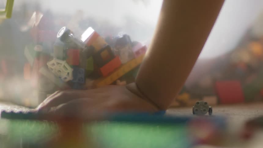 A young child plays with building block toys