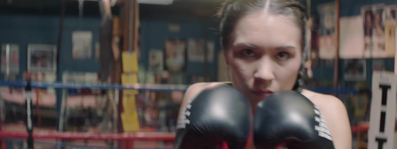 A woman boxer trains in a gym