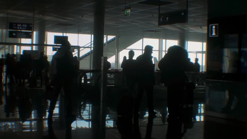 Travelers walk in an airport
