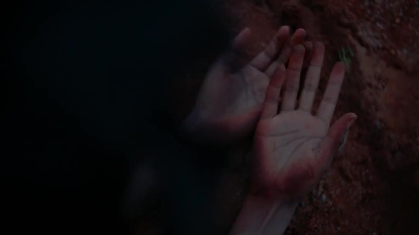 A person holds out their dirty hands