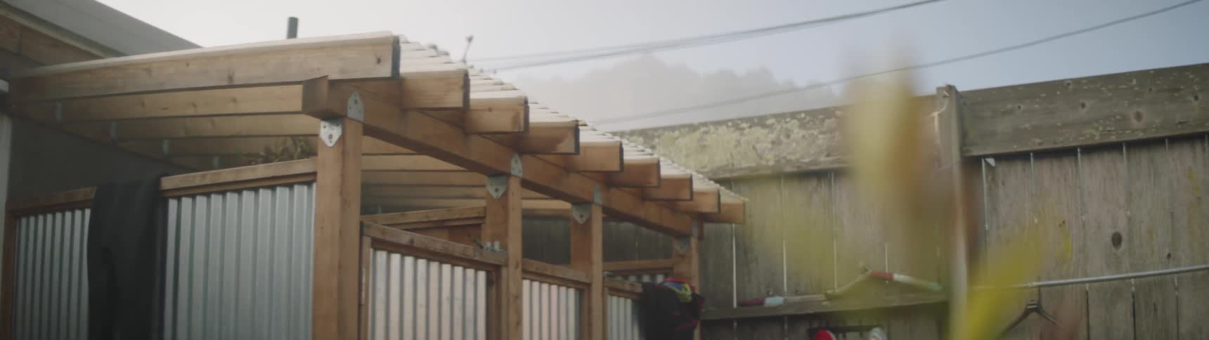 A wooden structure next to a fence outside