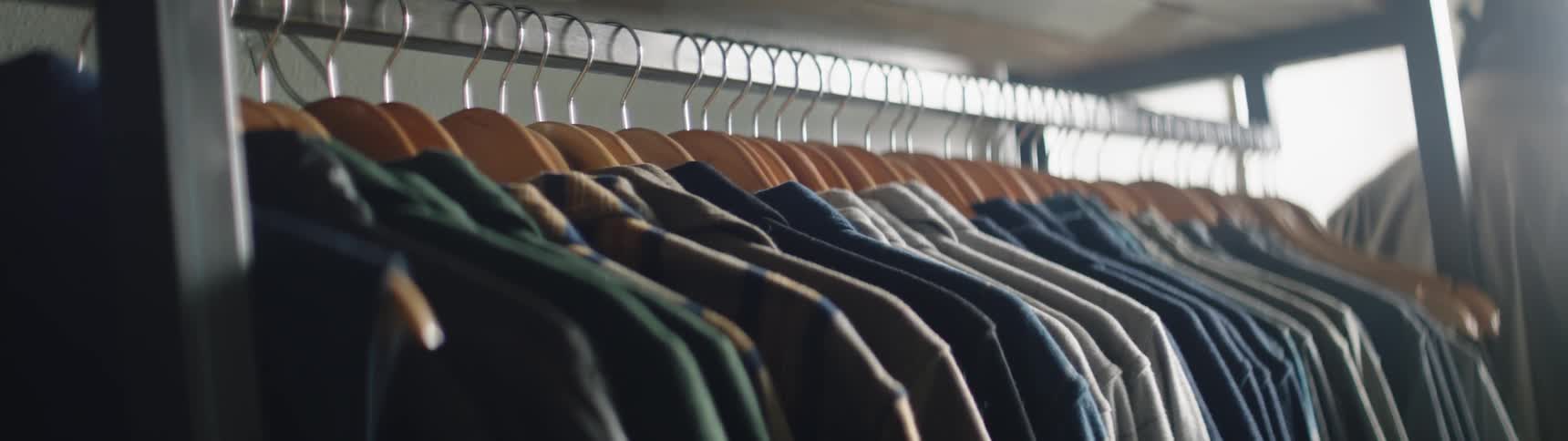 Shirts hang on a rack in a boutique
