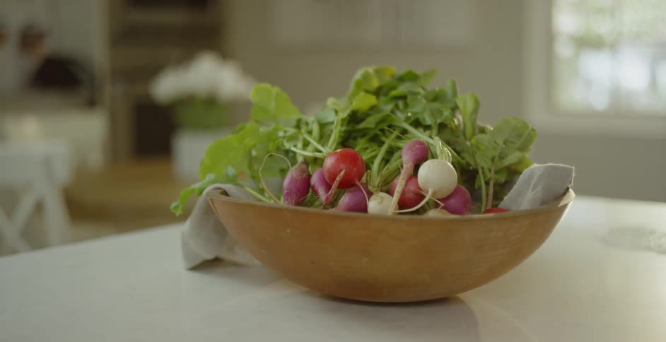 Beets and greens are together in a wood bowl