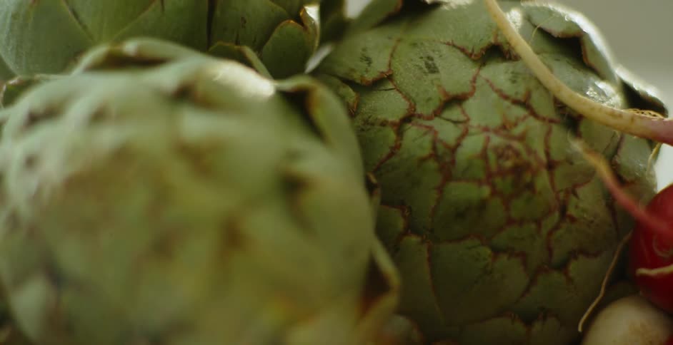 Green vegetables and beets are displayed on a countertop