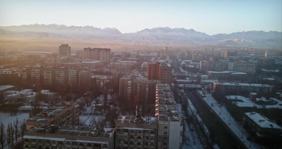 A large city with mountains behind it