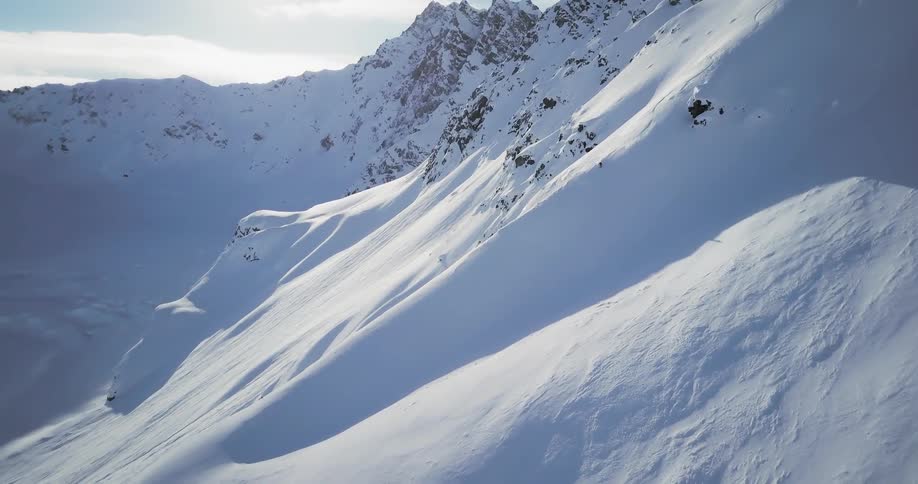 Person skiing down a large mountain