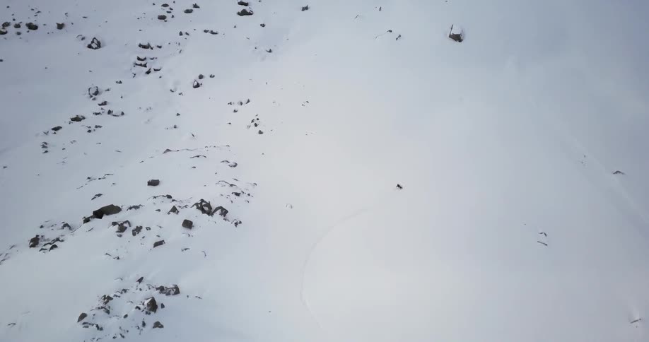 A skier is skiing down a snowy mountain
