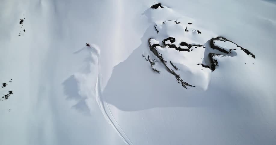A person skis through crisp white snow