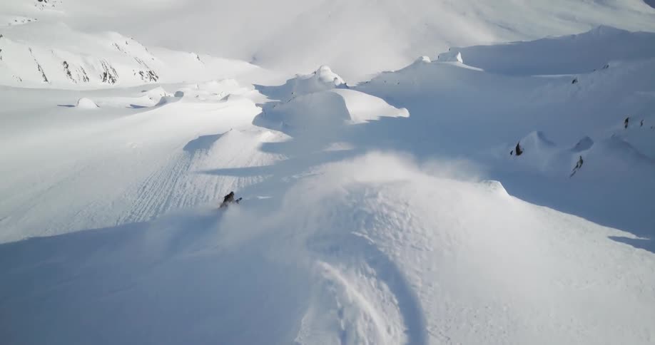 A skier descends down the slope