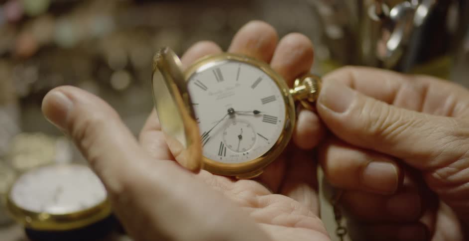 A man opens a pocket watch