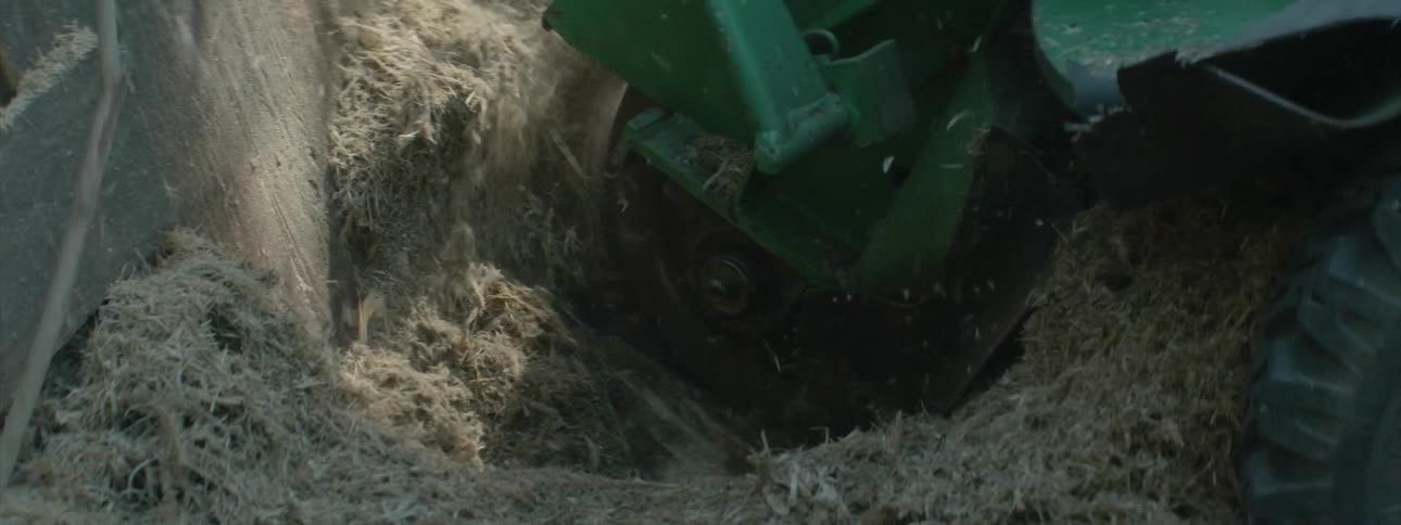 Machine cutting through some material and leaving finely shredded pieces