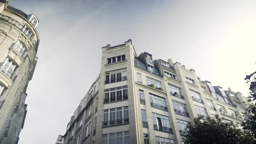 Buildings stand on a city street