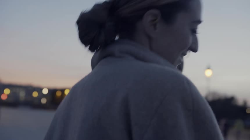 A man and woman walk out together at night