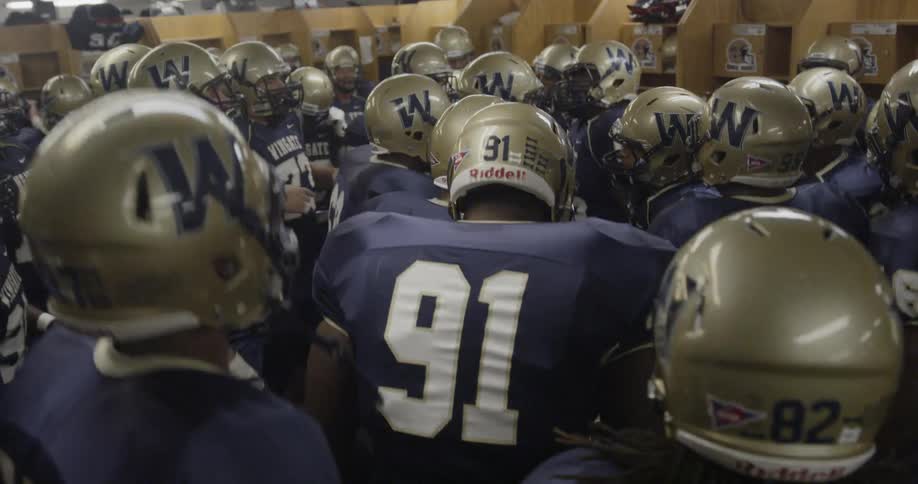 Football players get revved up in locker room