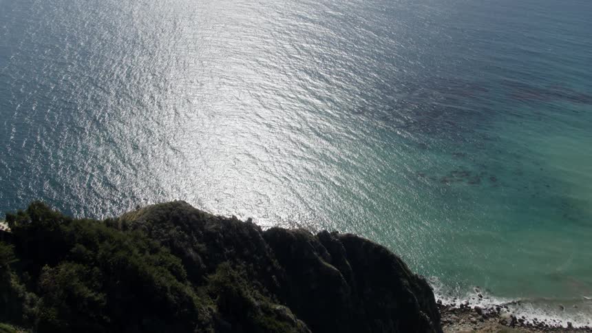 A ridge overlooks the ocean shore
